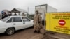 KAZAKHSTAN -- Police officers wearing a protective gear are seen at a checkpoint set up to lock down the city to prevent the spread of the COVID-19 coronavirus disease, on the outskirts of Almaty, March 23, 2020